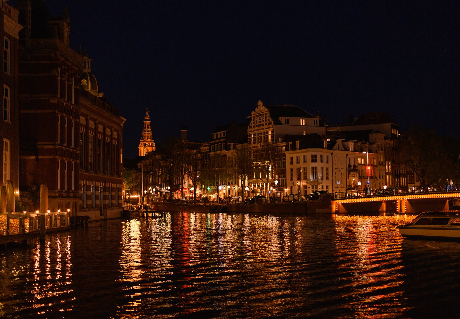 Canal Glow Night view of canal houses reflecting lights on the Amstel River in Amsterdam.