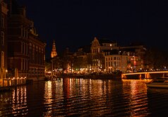 Canal Glow Night view of canal houses reflecting lights on the Amstel River in Amsterdam.