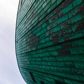 Curved Copper Close-up of the curved copper exterior of the NEMO Science Museum in Amsterdam.
