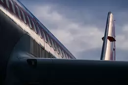 Winged Geometry A rear view of a commercial jet reveals clean metallic lines under a moody sky.