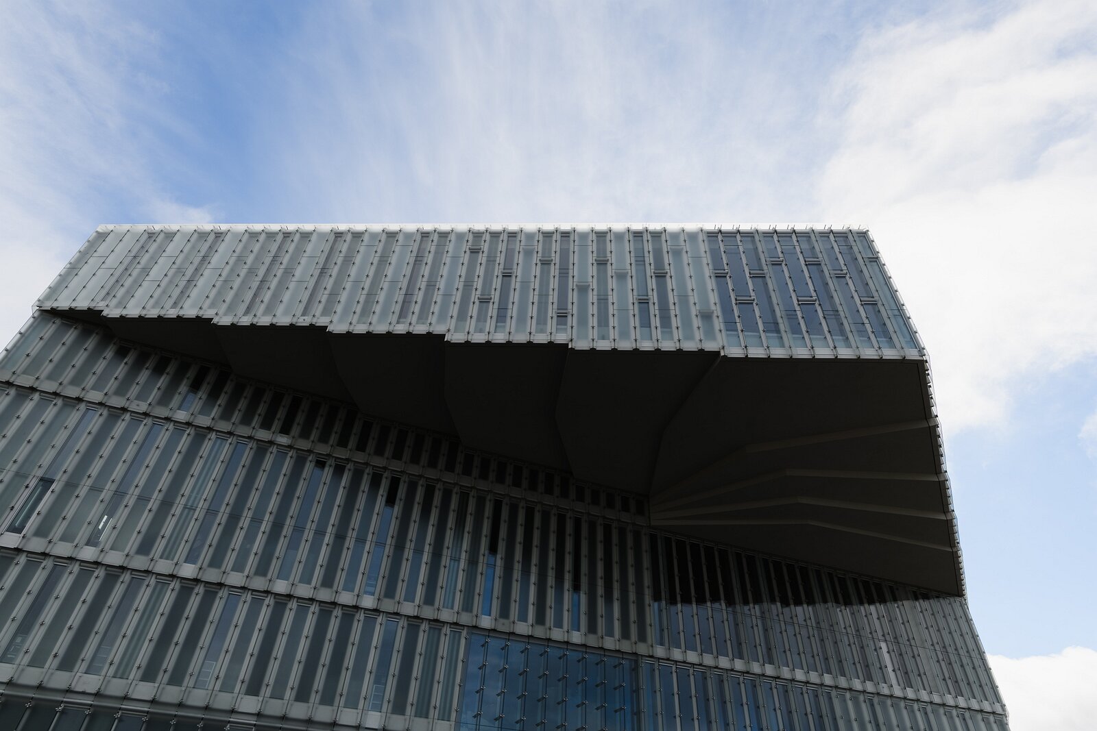 Library Overhang Cantilevered glass facade of the Deichman Bjørvika Library viewed from below in Oslo.