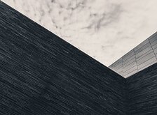 Stark Geometry Angled dark brick facade meets an overcast sky in Oslo.