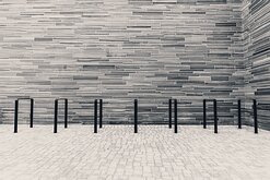 Slate Stripes Horizontal stone-clad courtyard with bike racks outside Oslo’s National Museum.