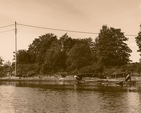 Silent Hull Sepia-toned remains of a wooden boat lie stranded on a calm Oslo inlet.