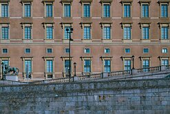 Royal Walls Exterior of Stockholm’s Royal Palace with rows of identical windows and a stone-lion balustrade in front.