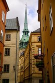 Spire Peek The slender green spire of the German Church (Tyska Kyrkan) rises above tight, pastel alleyways in Gamla Stan.