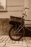 Rustic Wheel A weathered cargo bicycle rests against a stucco wall on a cobblestone lane in Stockholm’s Old Town.