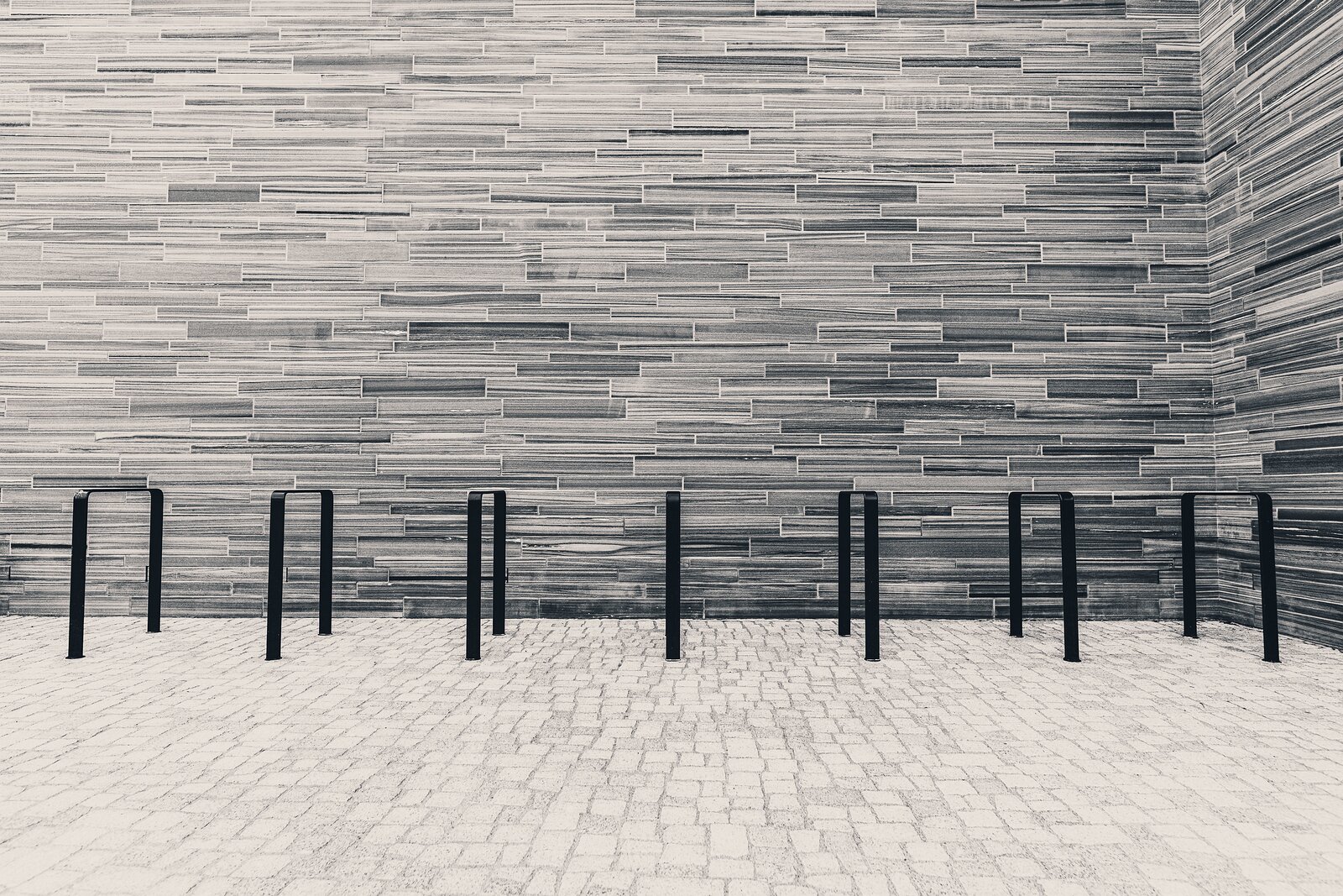 Slate Stripes Horizontal stone-clad courtyard with bike racks outside Oslo’s National Museum.