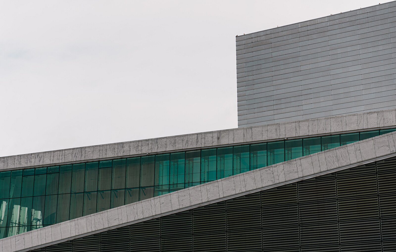 Glass Ribbon Sloping marble roofline and green-tinted glass of the Oslo Opera House.