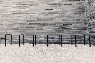 Slate Stripes Horizontal stone-clad courtyard with bike racks outside Oslo’s National Museum.